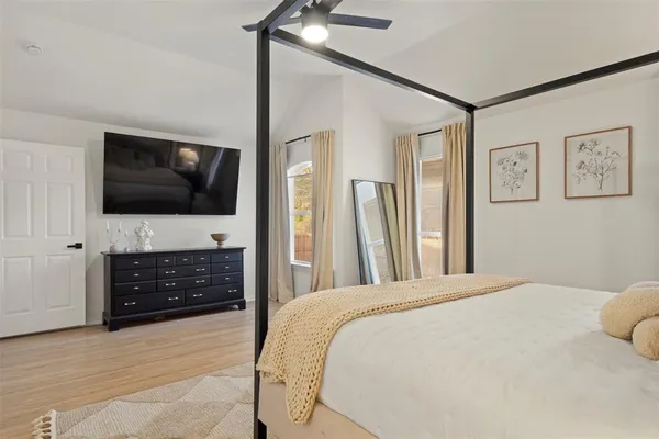 a bedroom with a bed and a flat screen tv