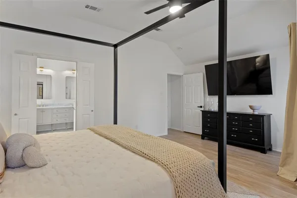 a bedroom with a bed and a flat screen tv