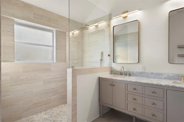 a bathroom with a granite countertop sink mirror and