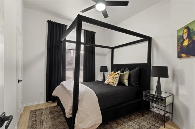 a bedroom with a bed lamps and table