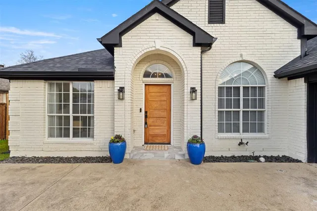 a view of a brick house with large windows