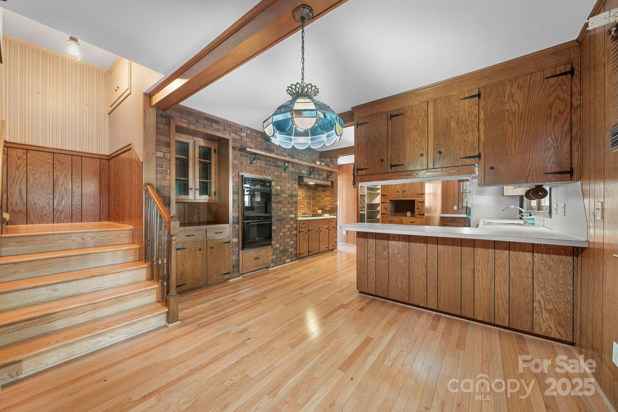 2551 Buffalo Shoals Road Newton, NC 28658 - Photo 14 of 47 a kitchen with stainless steel appliances granite countertop a sink dishwasher a microwave oven and a dining table with wooden floor
