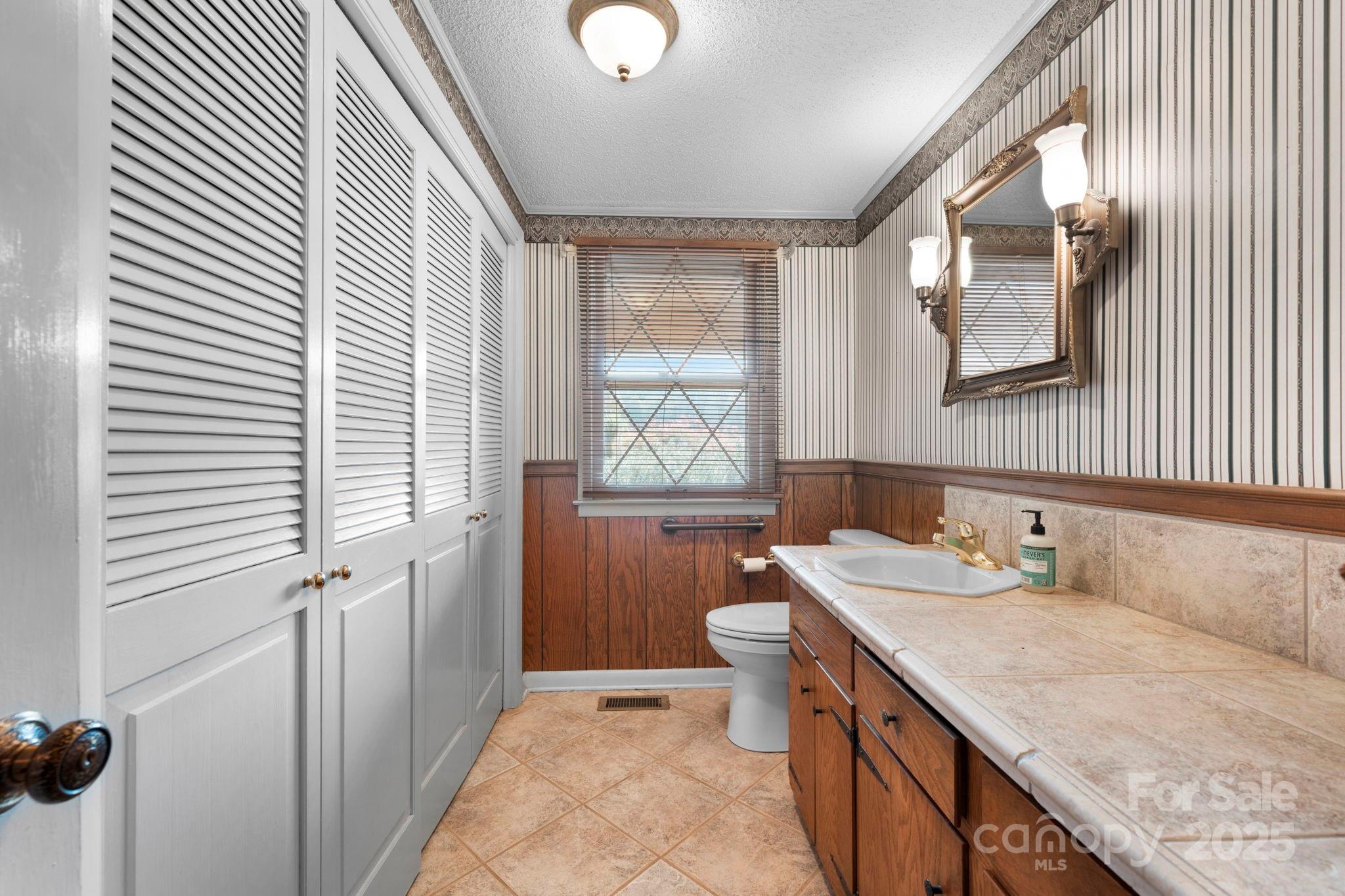 2551 Buffalo Shoals Road Newton, NC 28658 - Photo 17 of 47 a bathroom with a granite countertop sink mirror vanity and a toilet