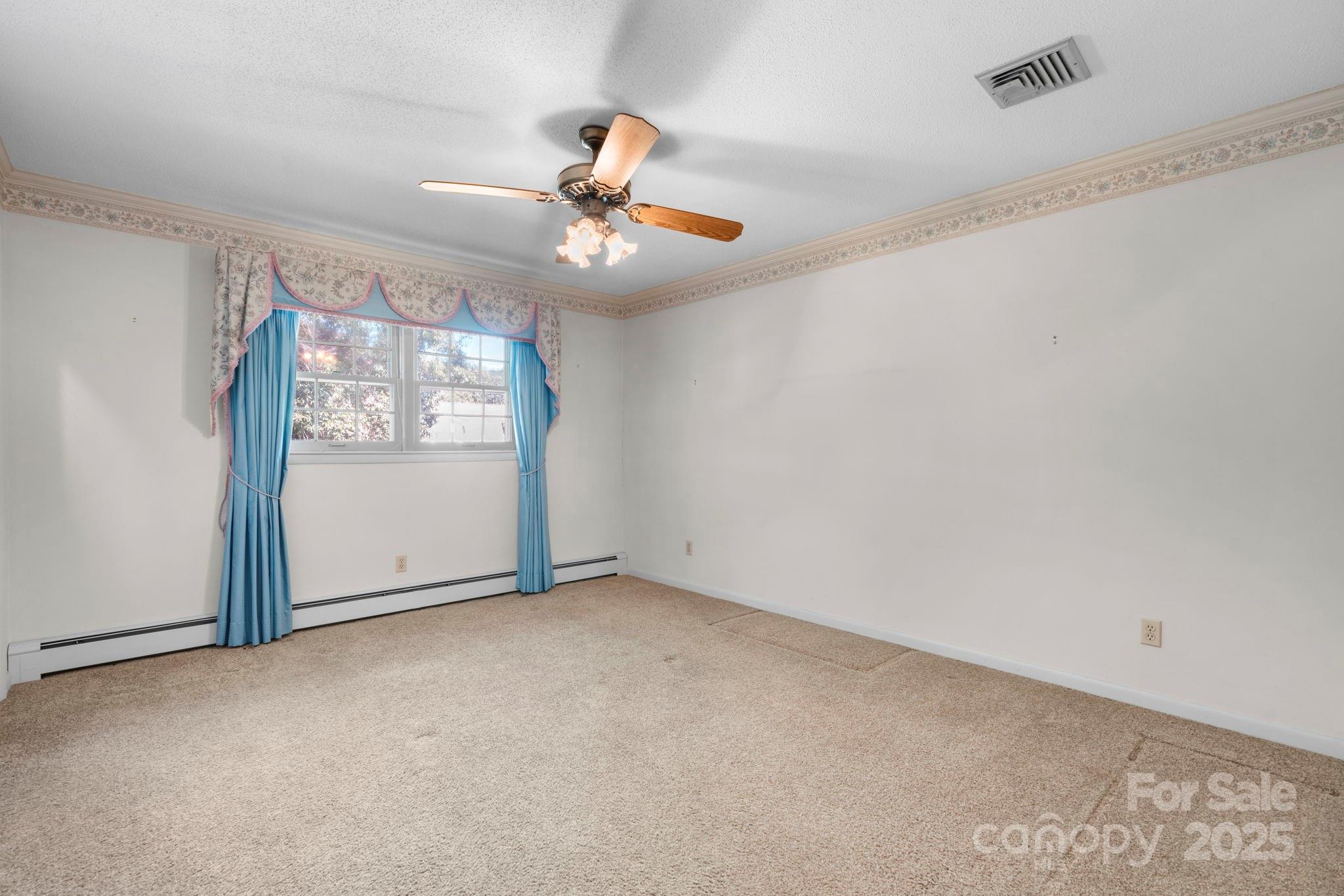2551 Buffalo Shoals Road Newton, NC 28658 - Photo 26 of 47 an empty room with windows and fan