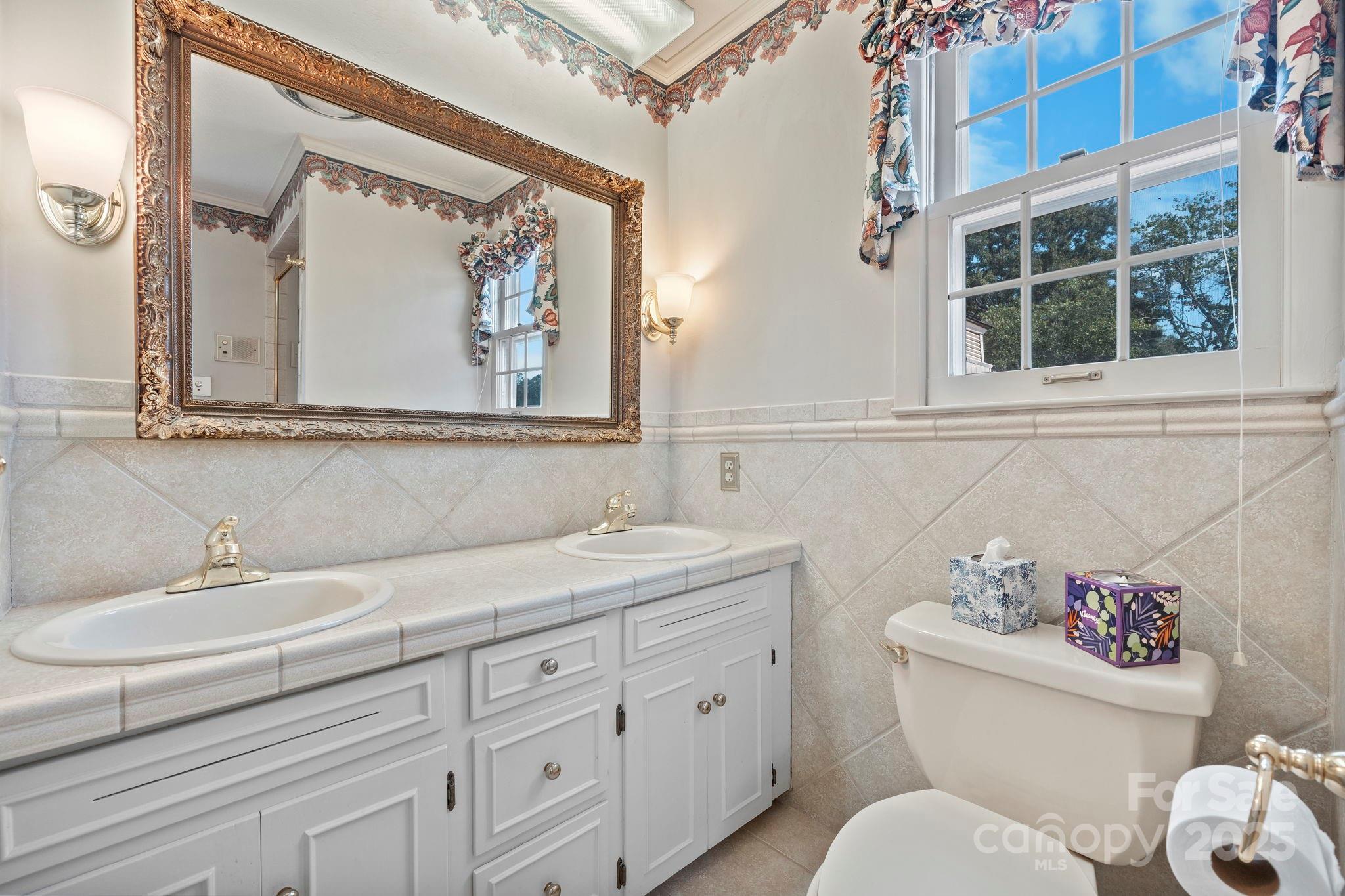2551 Buffalo Shoals Road Newton, NC 28658 - Photo 30 of 47 a bathroom with a toilet a sink and a mirror