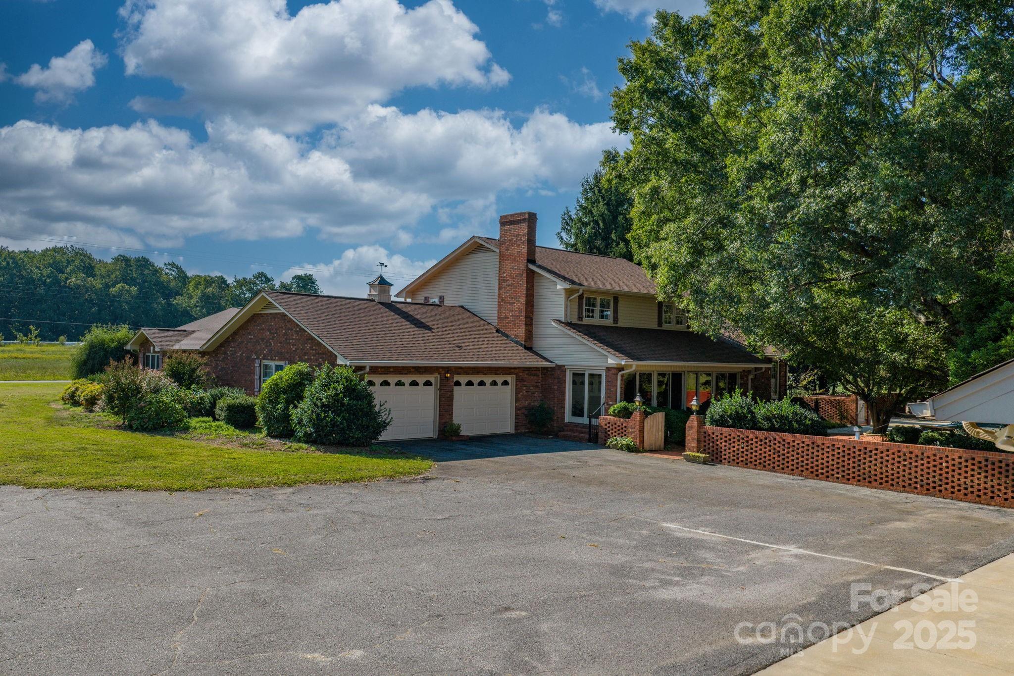 2551 Buffalo Shoals Road Newton, NC 28658 - Photo 3 of 47 a view of a white house with a big yard and large trees