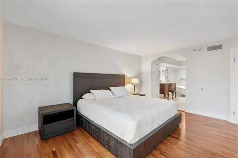 a bedroom with a bed and a night stand