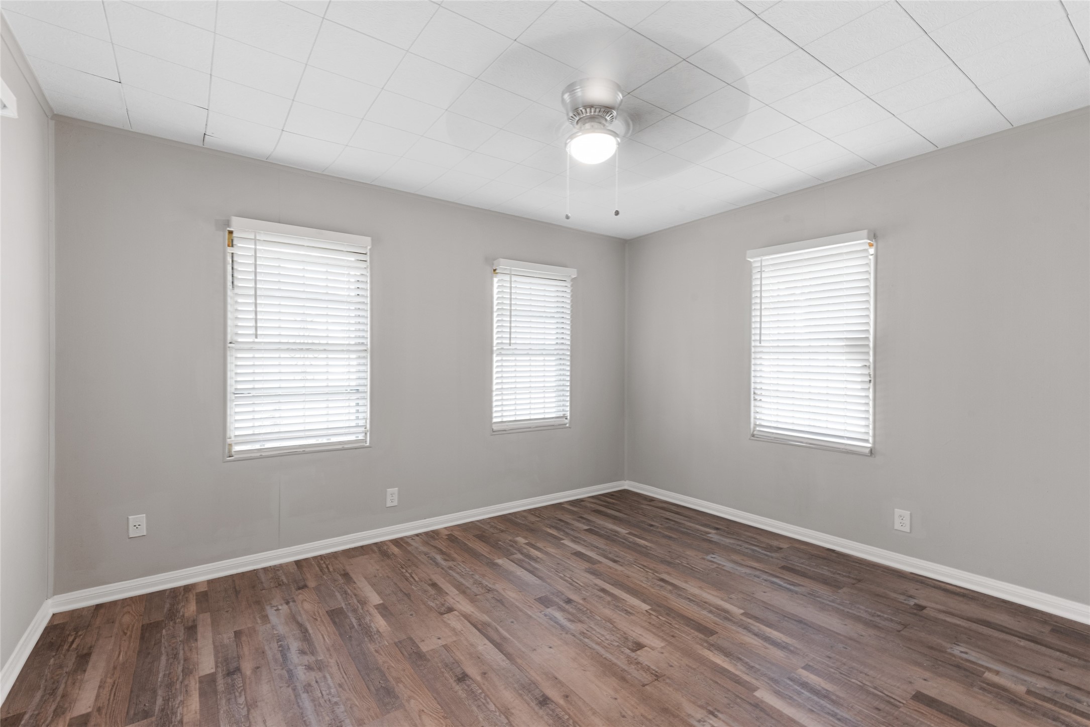 3734 Daphne Street Houston, TX 77021 - Photo 11 of 17 a view of an empty room with wooden floor and a window