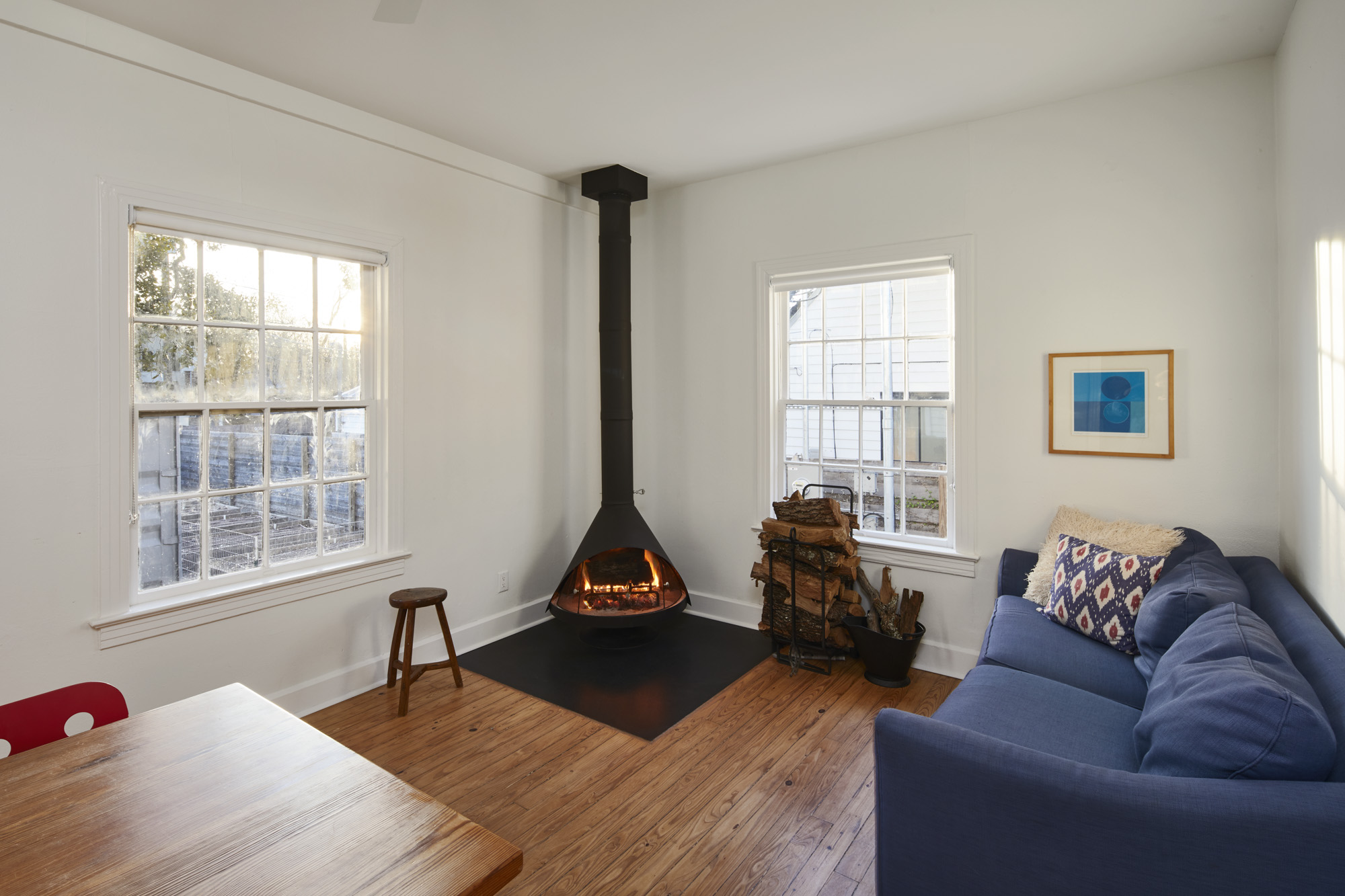 902 West Mary Street, Unit 1 Austin, TX 78704 - Photo 3 of 16 Living area with a wood stove, hardwood / wood-style floors, and plenty of natural light