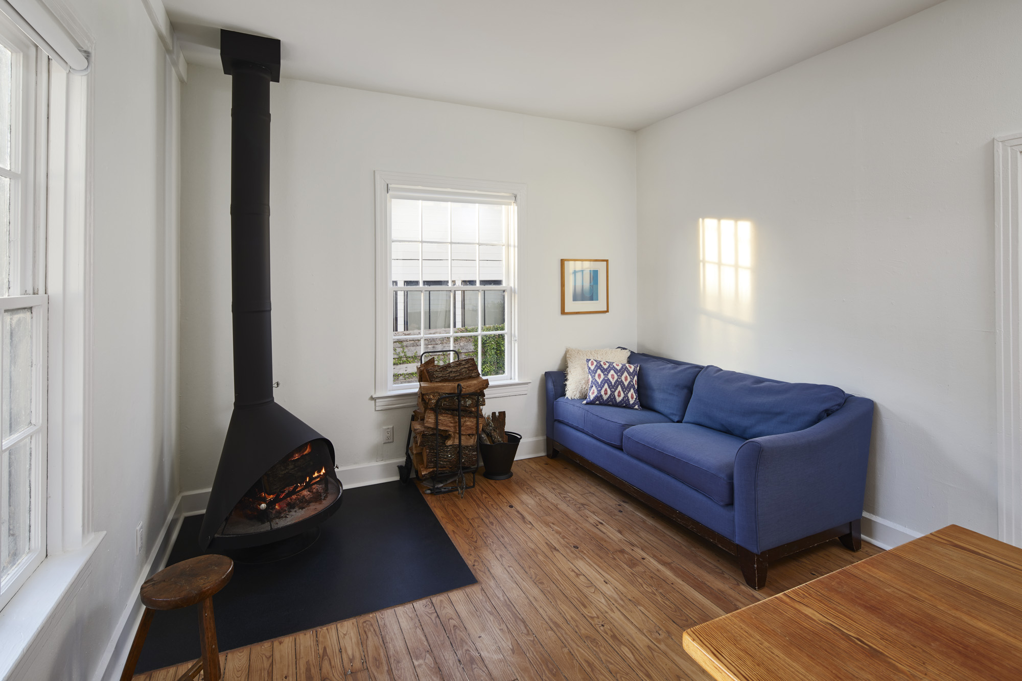 902 West Mary Street, Unit 1 Austin, TX 78704 - Photo 5 of 16 Living room with a wood stove and hardwood / wood-style floors