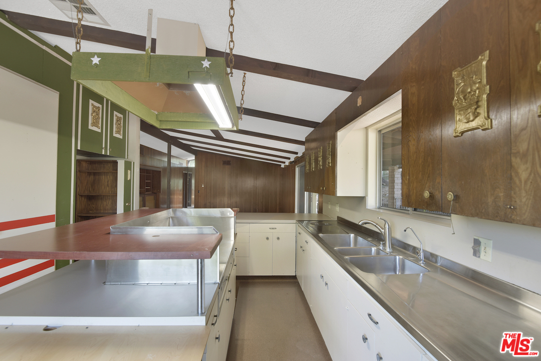 145 Old Church Road Topanga, CA 90290 - Photo 14 of 37 a large kitchen with a large window and stainless steel appliances
