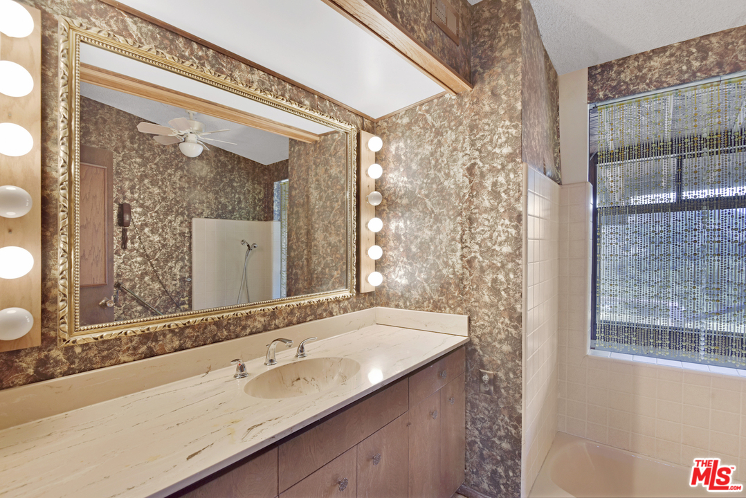 145 Old Church Road Topanga, CA 90290 - Photo 25 of 37 a bathroom with a granite countertop sink and a mirror