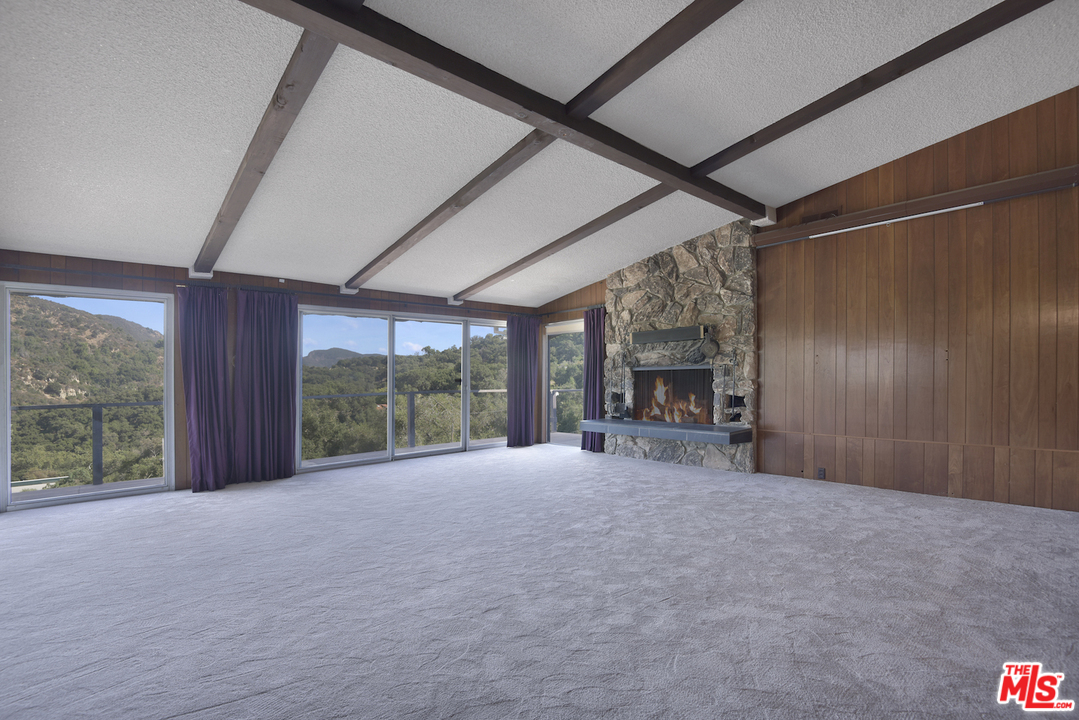 145 Old Church Road Topanga, CA 90290 - Photo 3 of 37 a view of large room with large windows and a fireplace