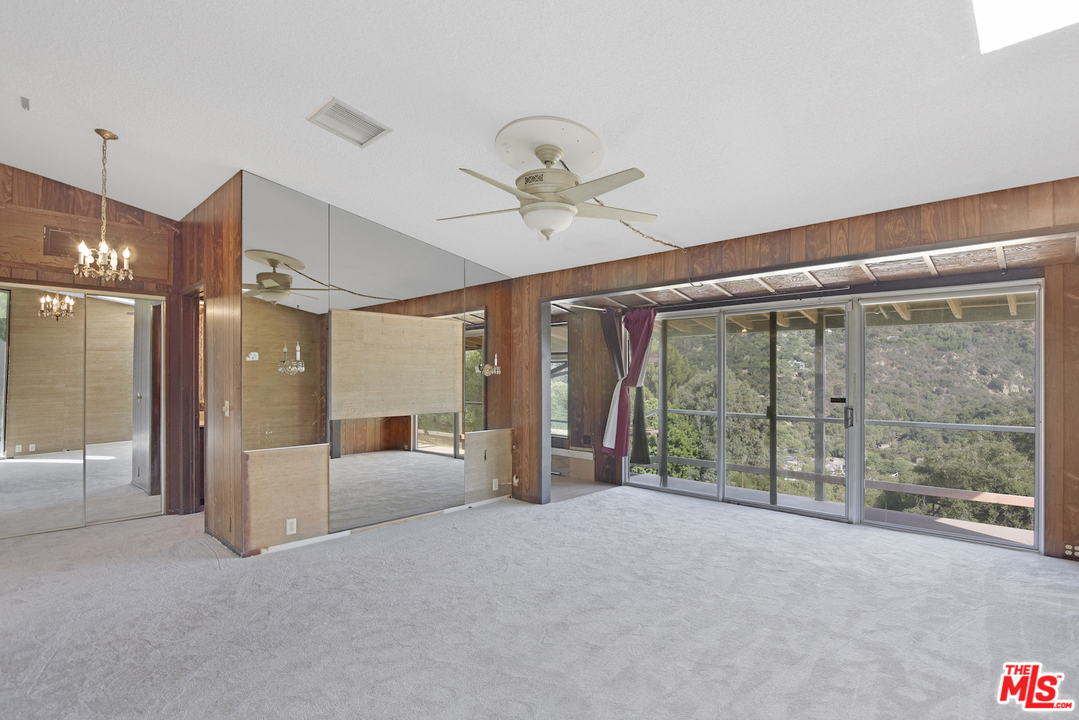 145 Old Church Road Topanga, CA 90290 - Photo 34 of 37 a view of an empty room with a fireplace and a chandelier