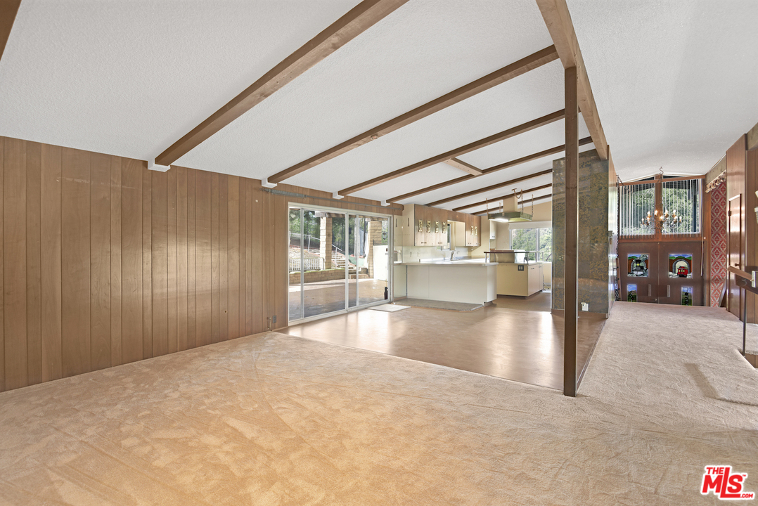 145 Old Church Road Topanga, CA 90290 - Photo 7 of 37 a view of a hallway with wooden floor and a living room