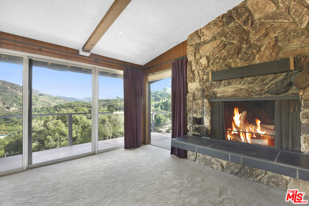 145 Old Church Road Topanga, CA 90290 - Photo 8 of 37 a living room with fireplace furniture and a flat screen tv