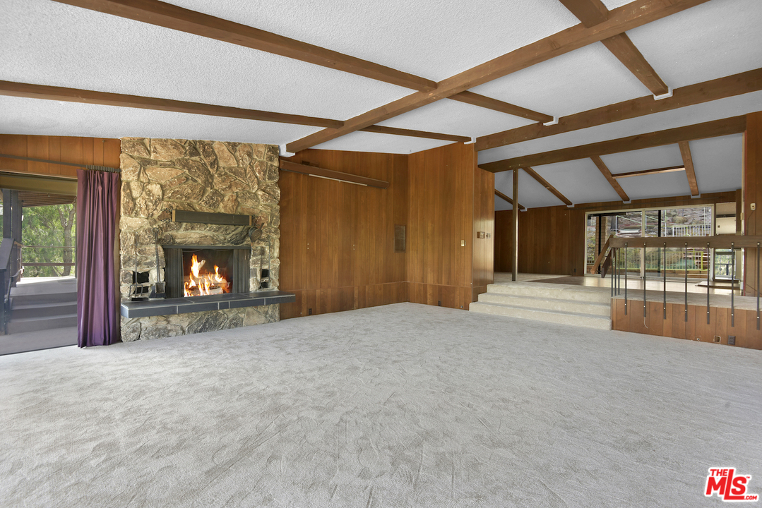 145 Old Church Road Topanga, CA 90290 - Photo 9 of 37 a view of an empty room with a fireplace and a window