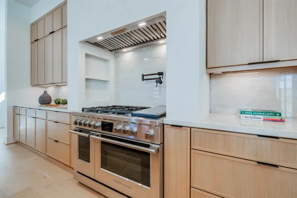 a large kitchen with stainless steel appliances lots of counter space and a sink