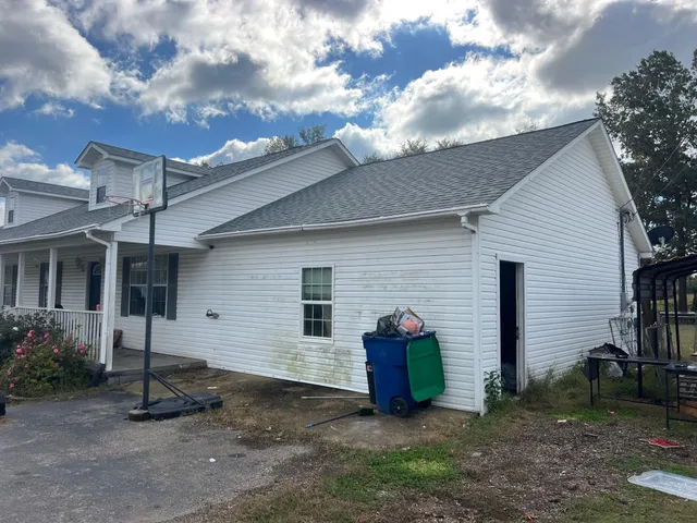 a view of a house with a yard and garage