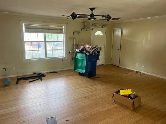 a living room with furniture and a pool table