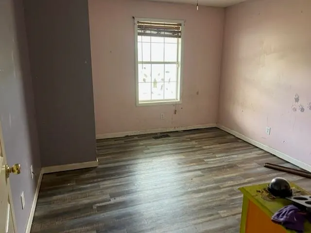 a view of wooden floor and windows in a room