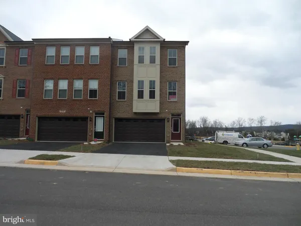 a view of a brick building next to a yard