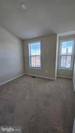 an empty room with windows and closet