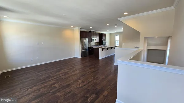 a view of a livingroom with furniture and staircase
