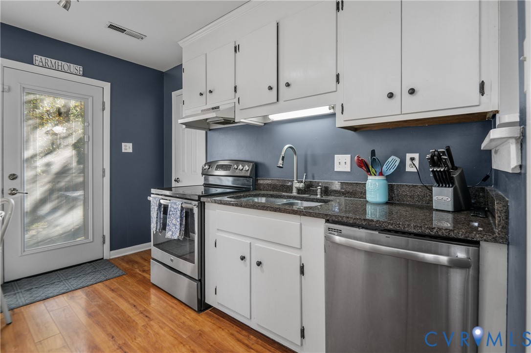 9901 Redbridge Road Chesterfield, VA 23236 - Photo 13 of 42 a kitchen with stainless steel appliances granite countertop a refrigerator and white cabinets