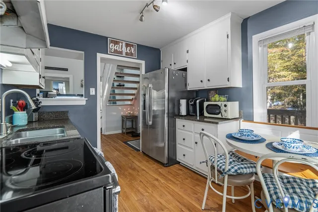 a kitchen with stainless steel appliances granite countertop a stove and a refrigerator