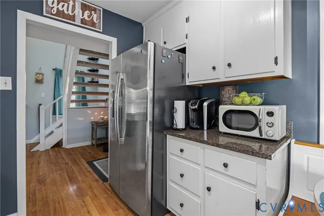 a kitchen with stainless steel appliances granite countertop a refrigerator and a stove