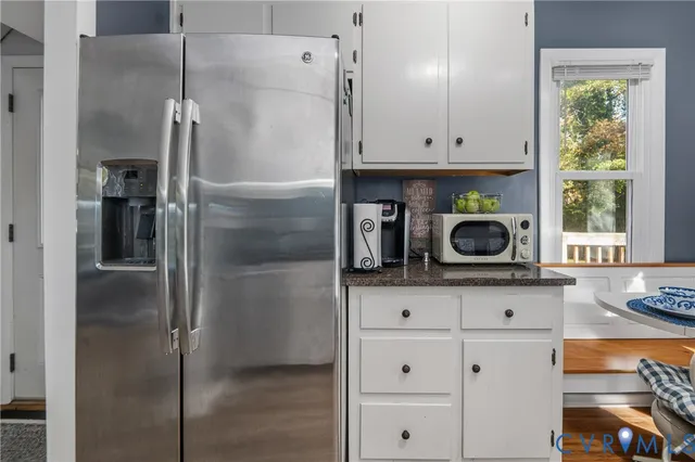 a kitchen with a refrigerator and a stove