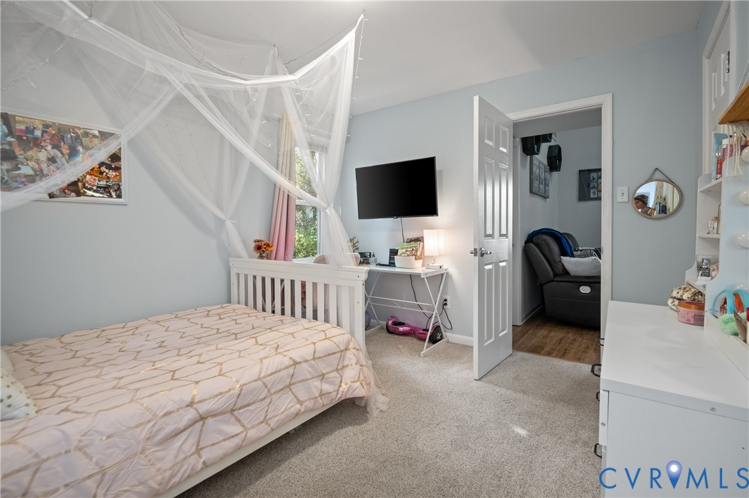 9901 Redbridge Road Chesterfield, VA 23236 - Photo 22 of 42 a bedroom with a bed and a flat tv screen on the dresser