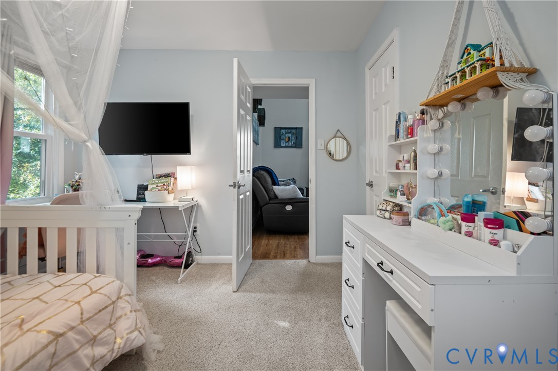 9901 Redbridge Road Chesterfield, VA 23236 - Photo 23 of 42 a bedroom with a bed and a flat tv screen on dresser