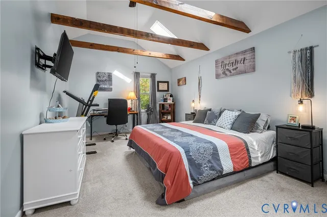 a spacious bedroom with a bed and a chandelier