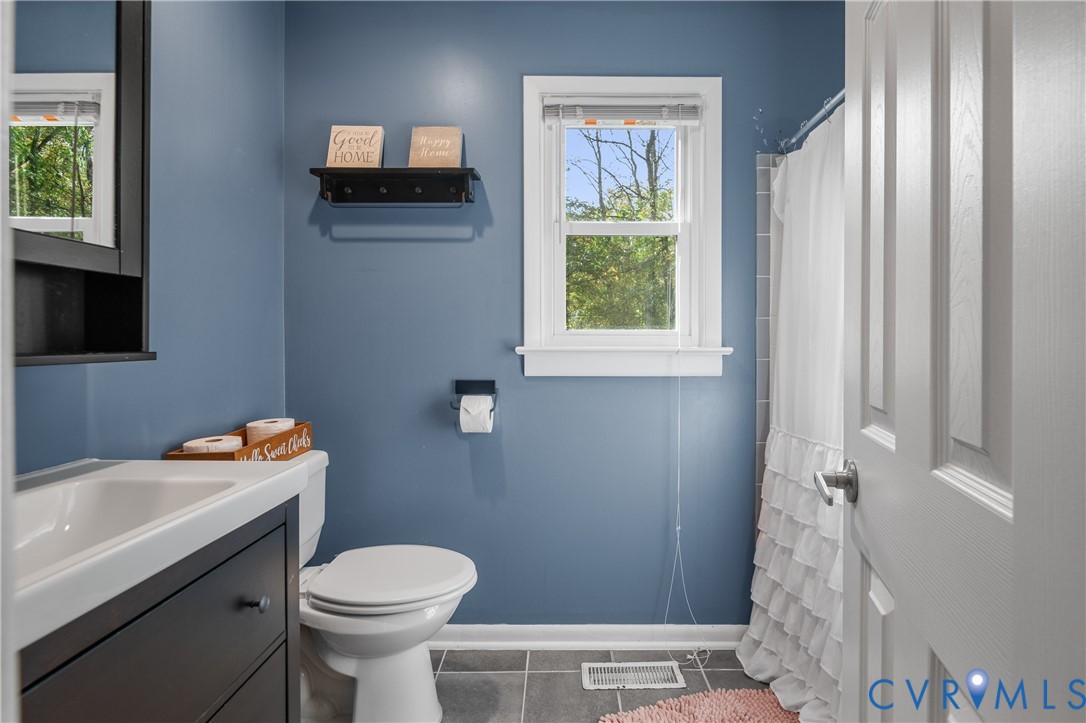 9901 Redbridge Road Chesterfield, VA 23236 - Photo 31 of 42 a bathroom with a sink a toilet and a window