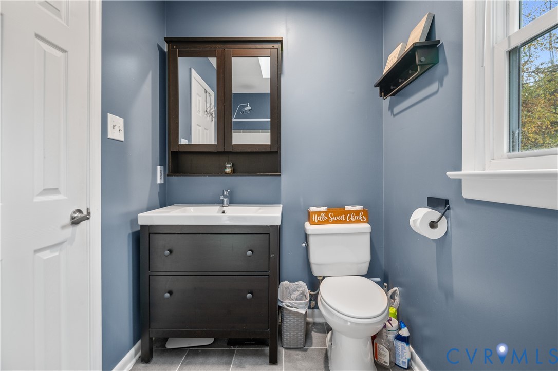 9901 Redbridge Road Chesterfield, VA 23236 - Photo 32 of 42 a bathroom with a toilet sink and mirror