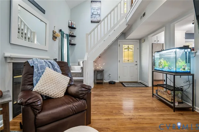 a living room with furniture and a floor to ceiling window