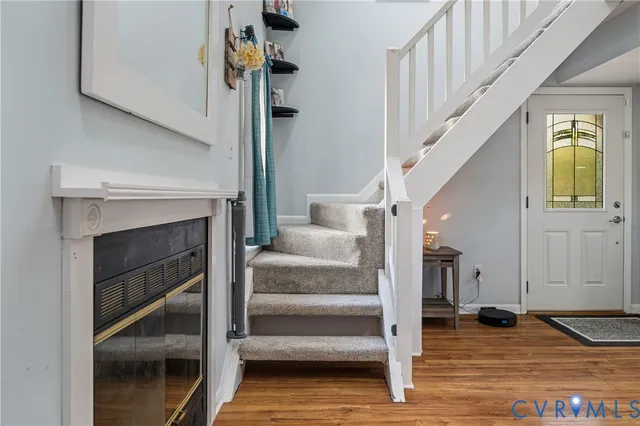 a view of entryway and hall with wooden floor