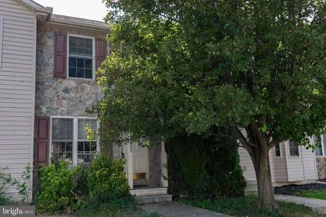 a front view of a house with trees