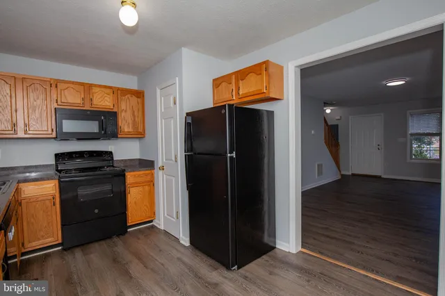 a kitchen with stainless steel appliances granite countertop a refrigerator and a stove top oven