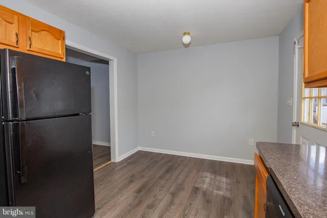 a room with a refrigerator and window