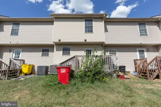 a view of a house with a yard and sitting area