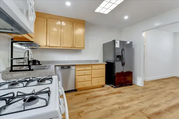 a kitchen with stainless steel appliances granite countertop a stove and a refrigerator