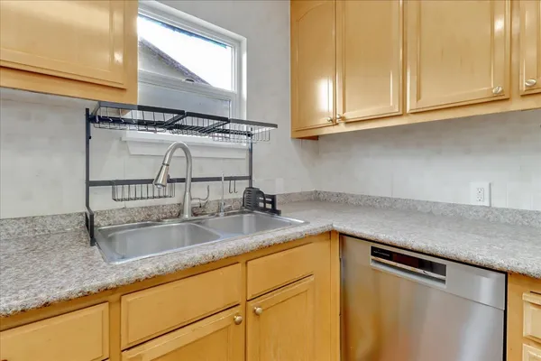 a kitchen with sink cabinets and window