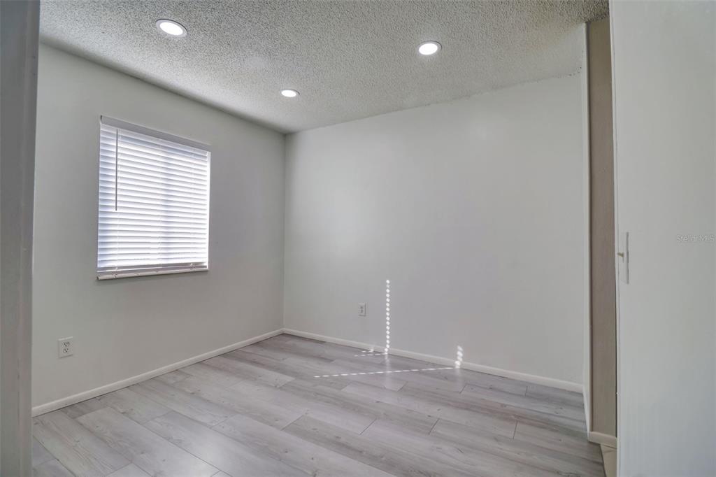 4004 Cortez Drive, Unit D Tampa, FL 33614 - Photo 12 of 30 an empty room with wooden floor and windows