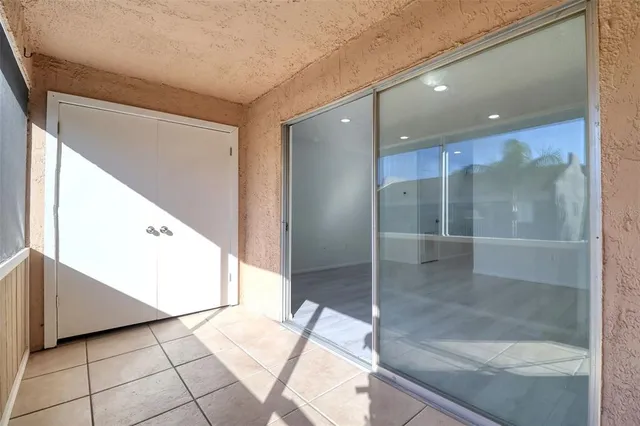 a view of a hallway to an empty room and entrance