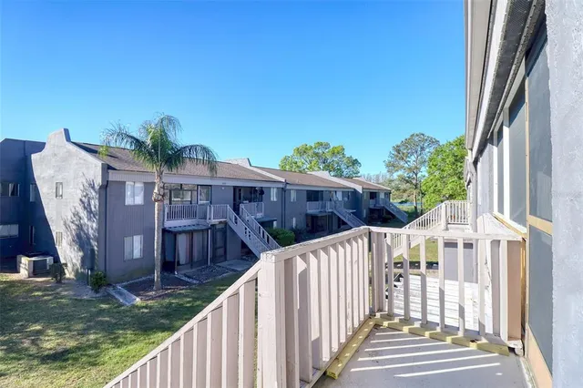 a view of a house with backyard and wooden fence