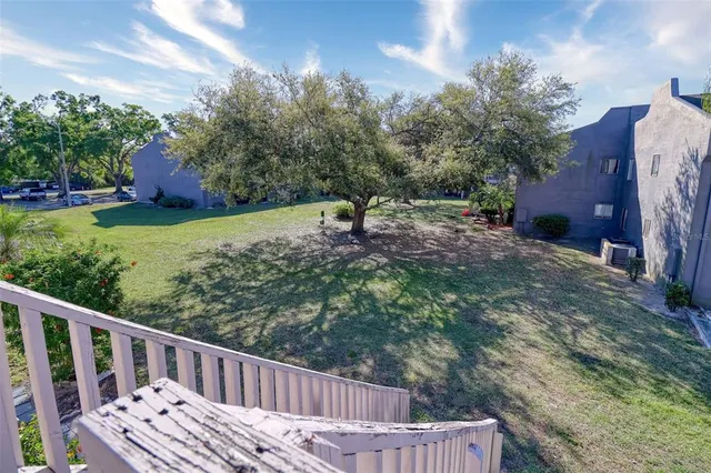 a view of a wooden deck and a yard