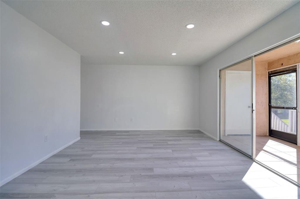 4004 Cortez Drive, Unit D Tampa, FL 33614 - Photo 3 of 30 wooden floor in an empty room with a window